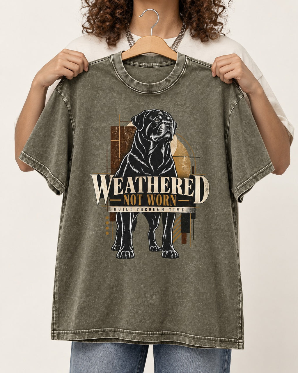 Rottweiler Weathered Not Worn Geometric Graphic Washed Tee in Army Green, held up on a hanger