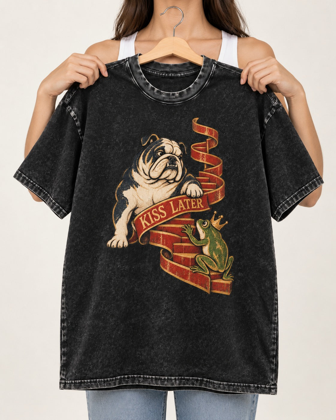 English Bulldog Kiss Later Frog Prince Graphic Washed Tee in Black, held up on a hanger