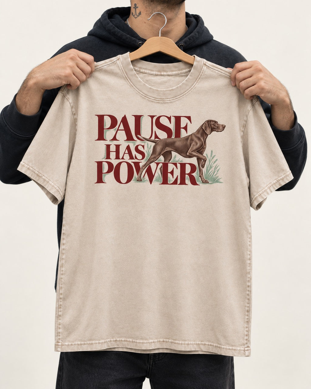 Pause Has Power German Shorthaired Pointer Washed Tee in Apricot, held up on a hanger