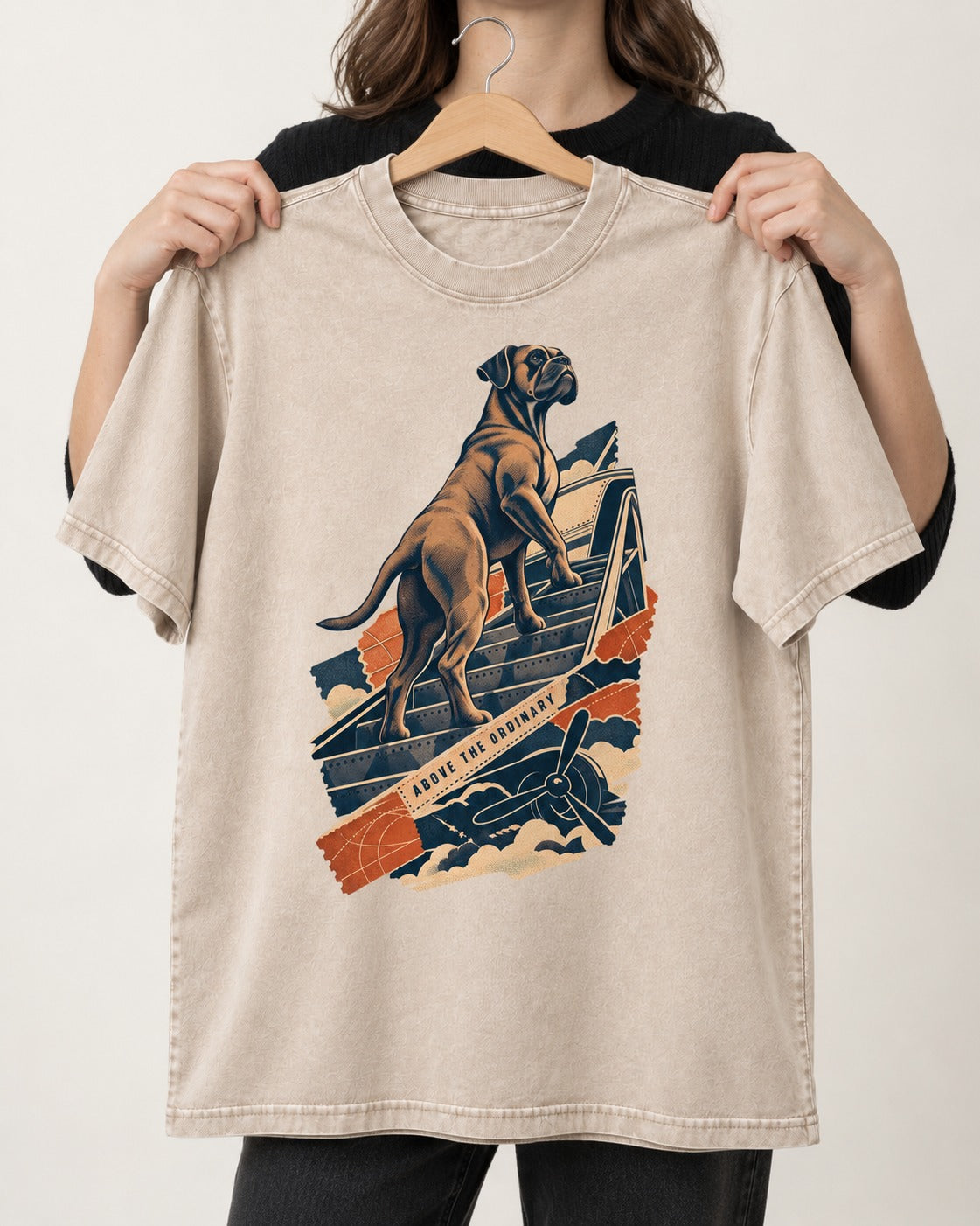 Above the Ordinary Boxer Aviation Graphic Washed Tee in Apricot, held up on a hanger