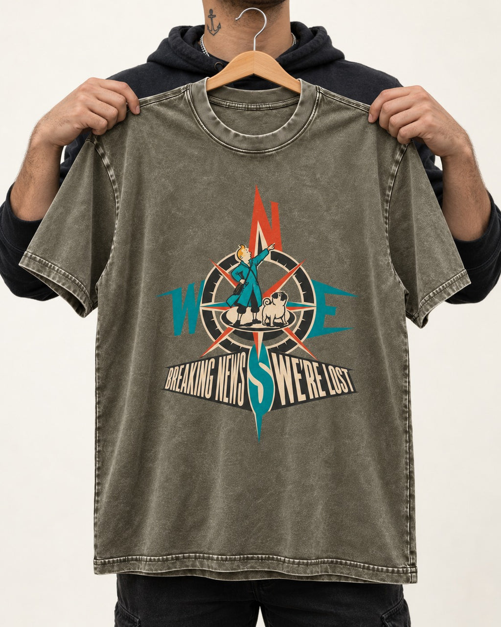 Pug Breaking News We're Lost Compass Graphic Washed Tee in Army Green, held up on a hanger
