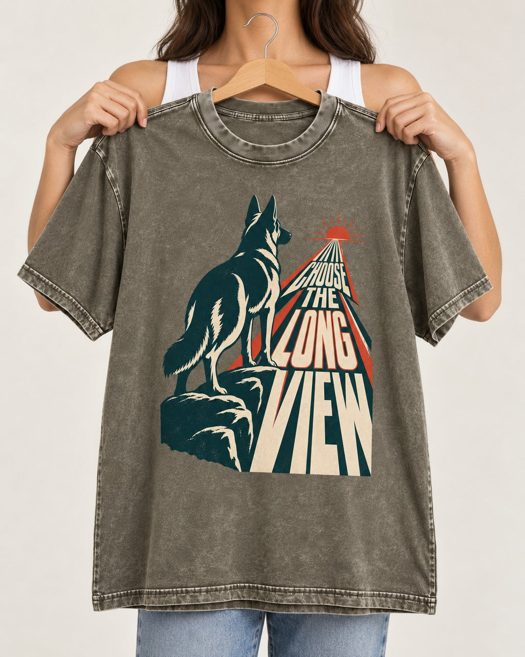 Choose the Long View Sunrise German Shepherd Dog Graphic Washed Tee in Army Green, held up on a hanger