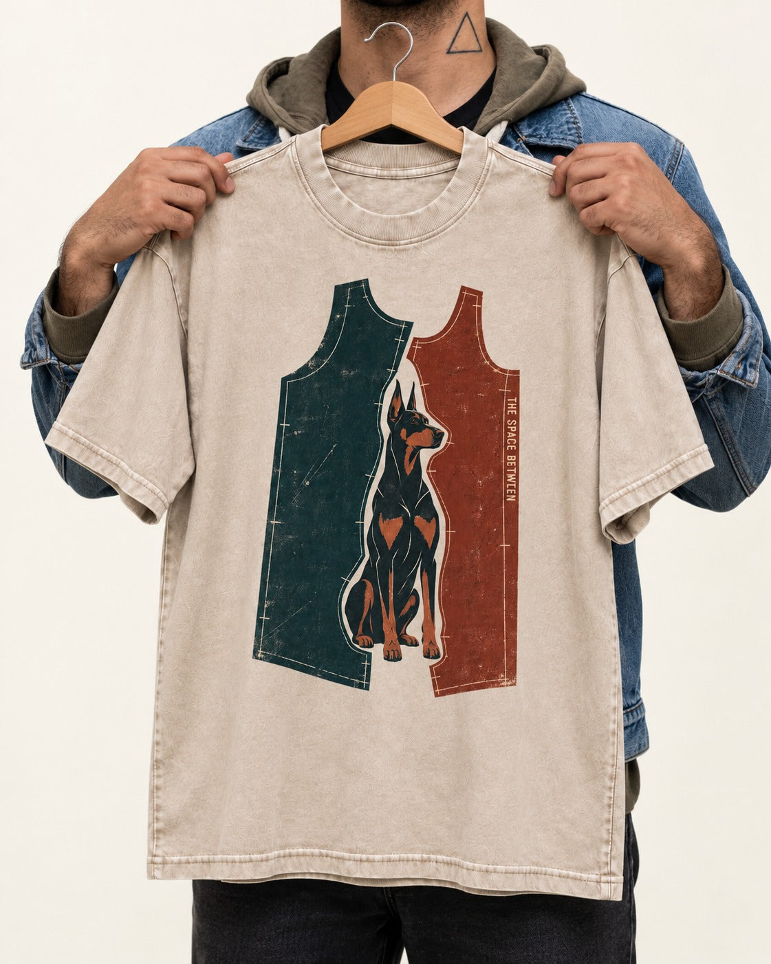 Doberman The Space Between Pattern Pieces Graphic Washed Tee in Apricot, held up on a hanger