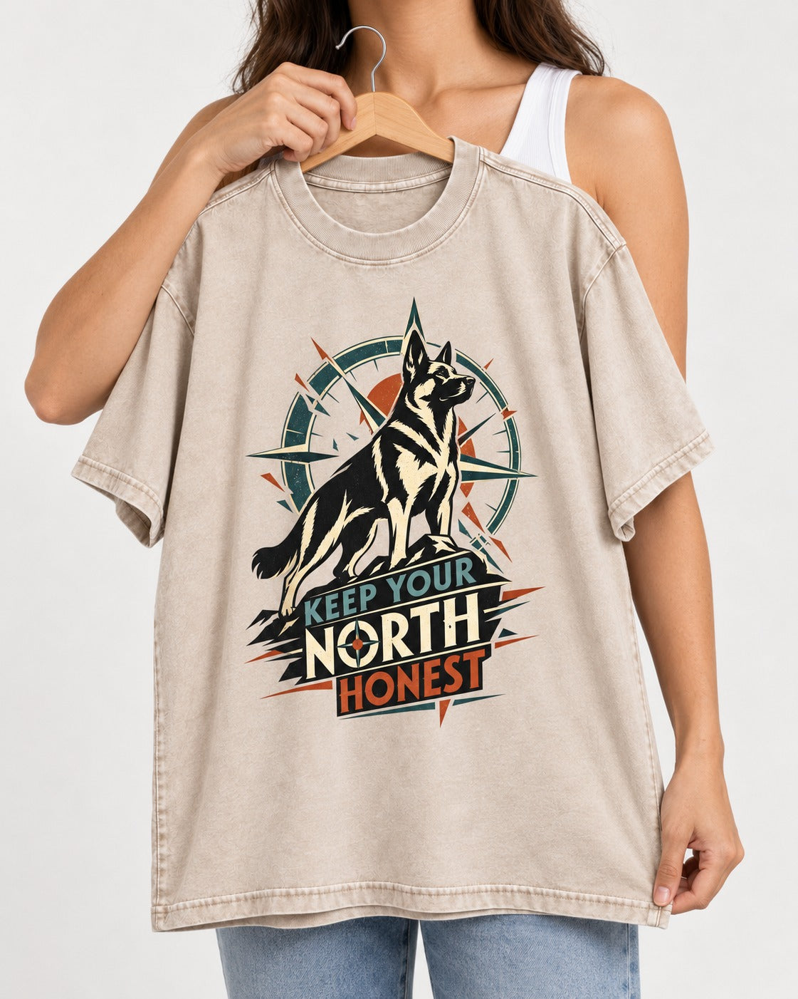 Keep Your North Honest Compass German Shepherd Dog Graphic Washed Tee in Apricot, held up on a hanger