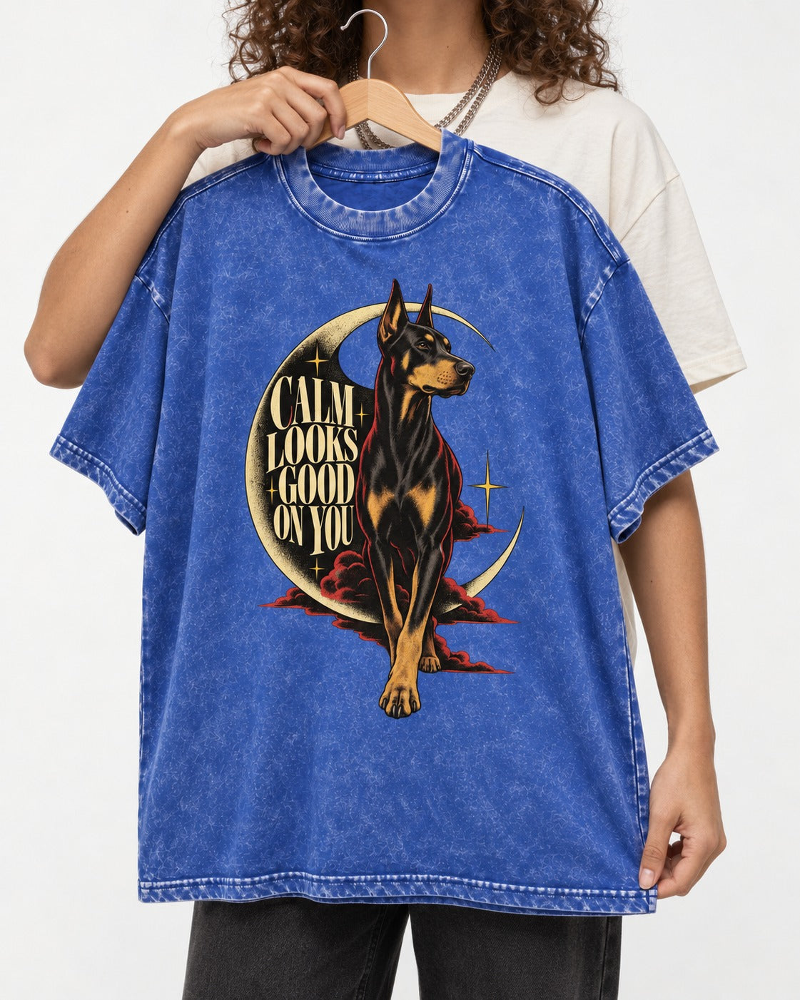 Doberman Calm Looks Good on You Crescent Graphic Washed Tee in Royal Blue, held up on a hanger