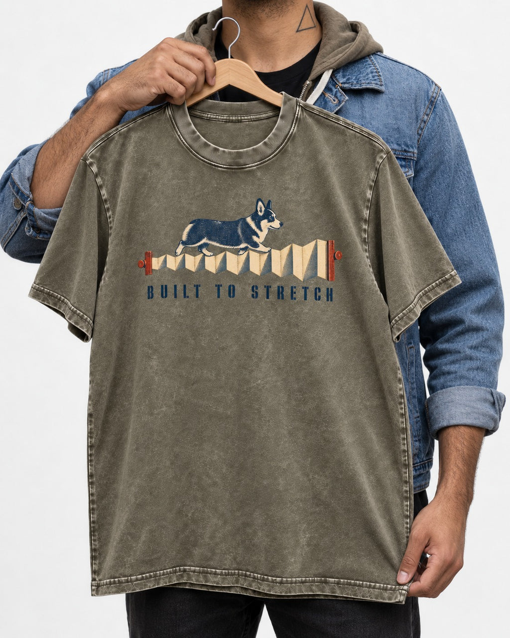 Corgi Built to Stretch Accordion Graphic Washed Tee in Army Green, held up on a hanger