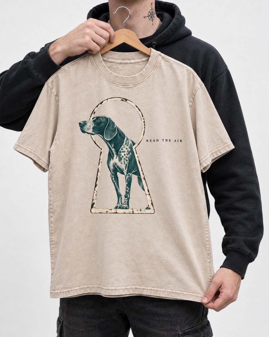 Read the Air German Shorthaired Pointer Washed Tee in Apricot, held up on a hanger