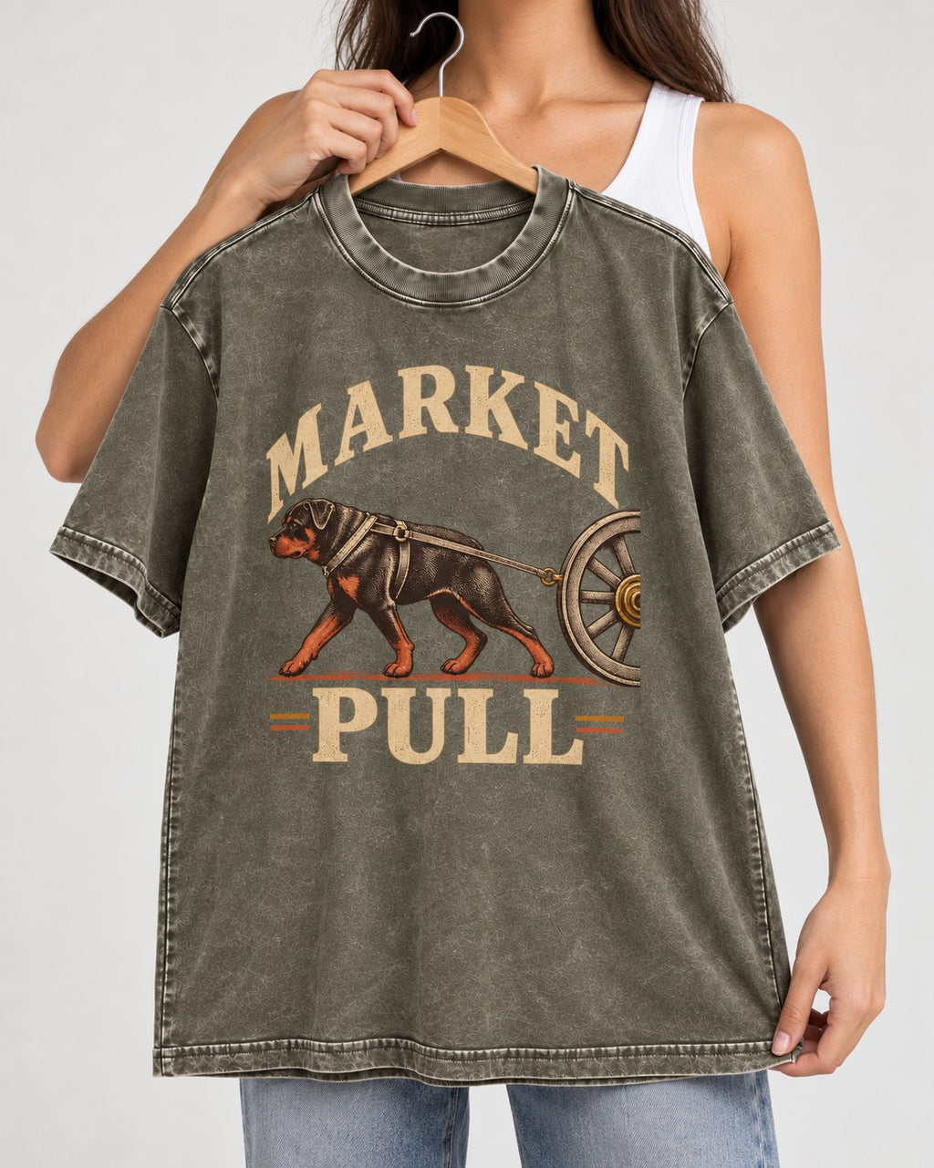 Market Pull Rottweiler Cart Harness Graphic Washed Tee in Army Green, held up on a hanger