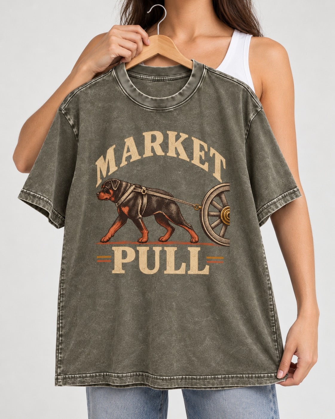 Market Pull Rottweiler Cart Harness Graphic Washed Tee in Army Green, held up on a hanger