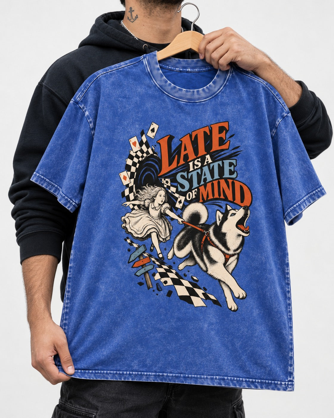 Husky Late Is a State of Mind Wonderland Chase Graphic Washed Tee in Royal Blue, held up on a hanger