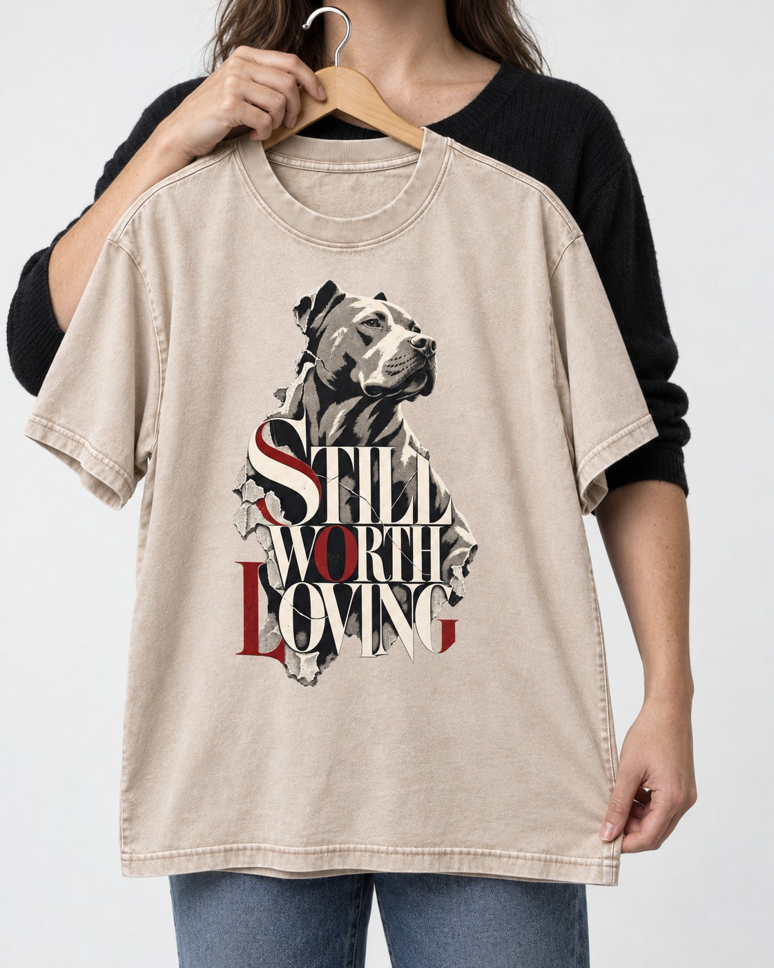 Pitbull Still Worth Loving Torn Poster Portrait Graphic Washed Tee in Apricot, held up on a hanger