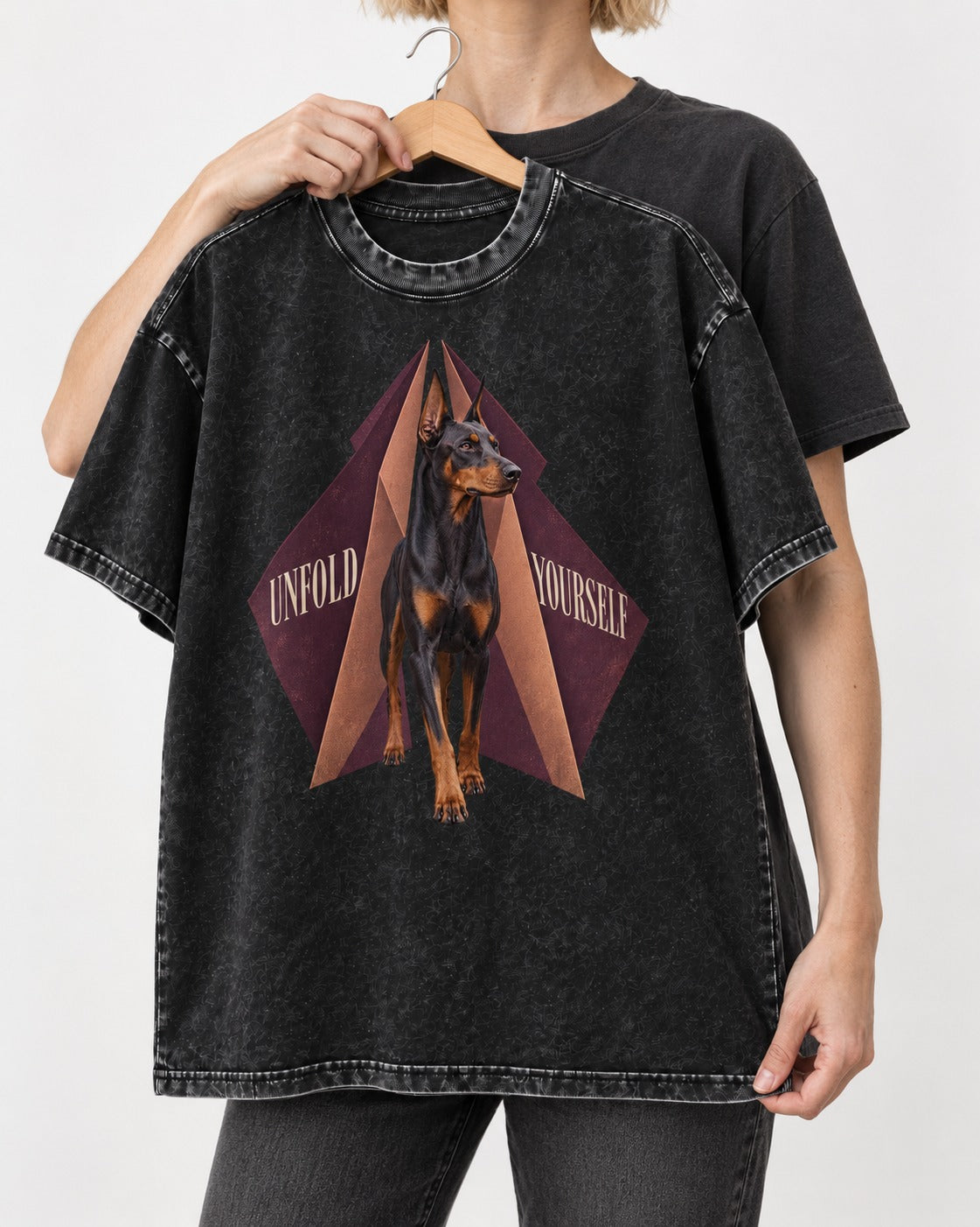 Doberman Unfold Yourself Geometric Portrait Graphic Washed Tee in Black, held up on a hanger