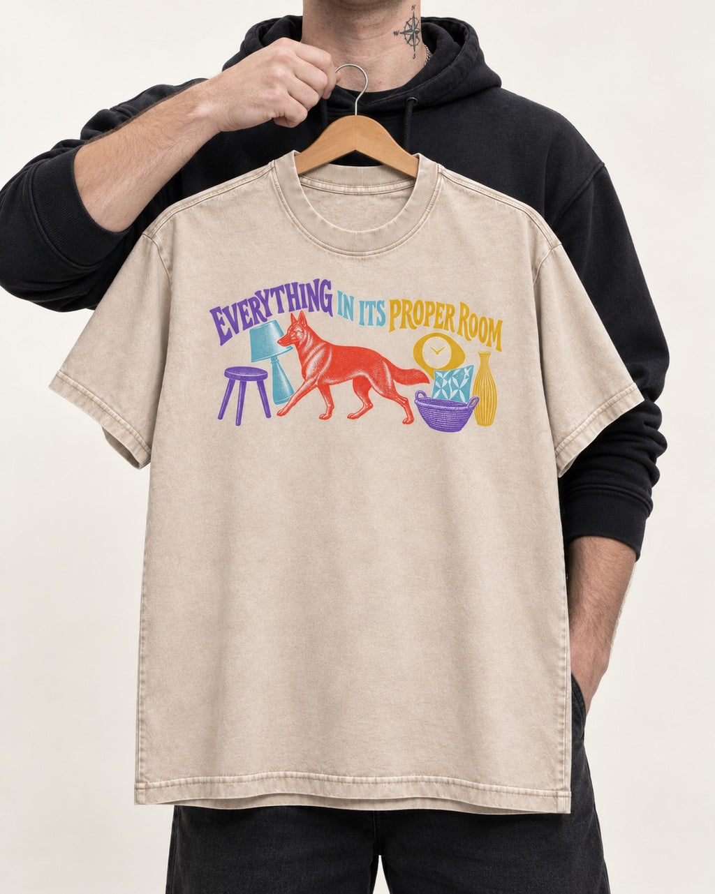 German Shepherd Dog In Its Proper Room Washed Tee in Apricot, held up on a hanger