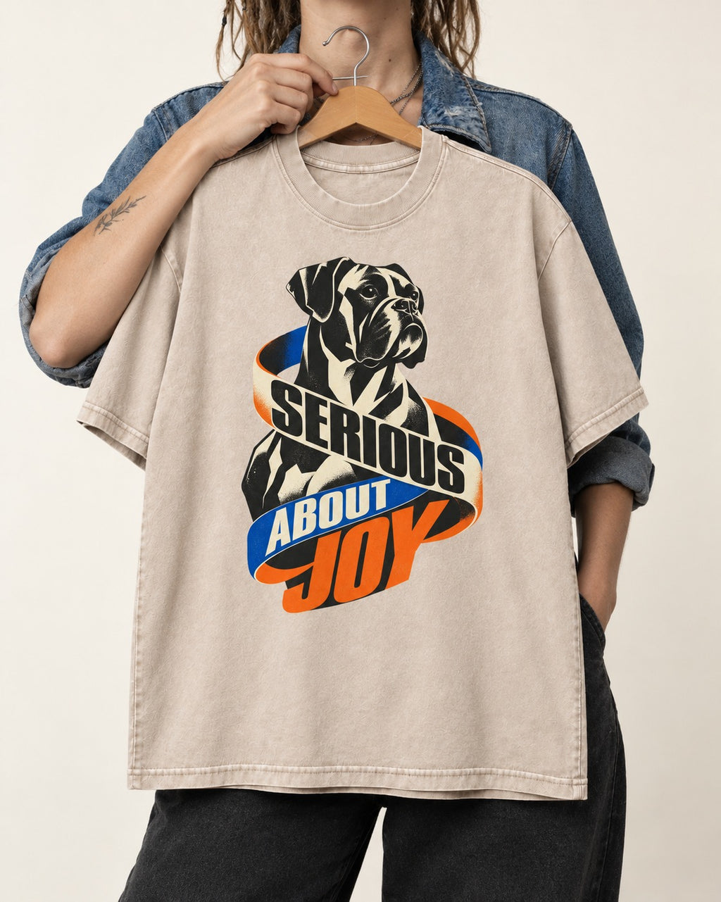 Boxer Serious About Joy Washed Tee in Apricot, held up on a hanger