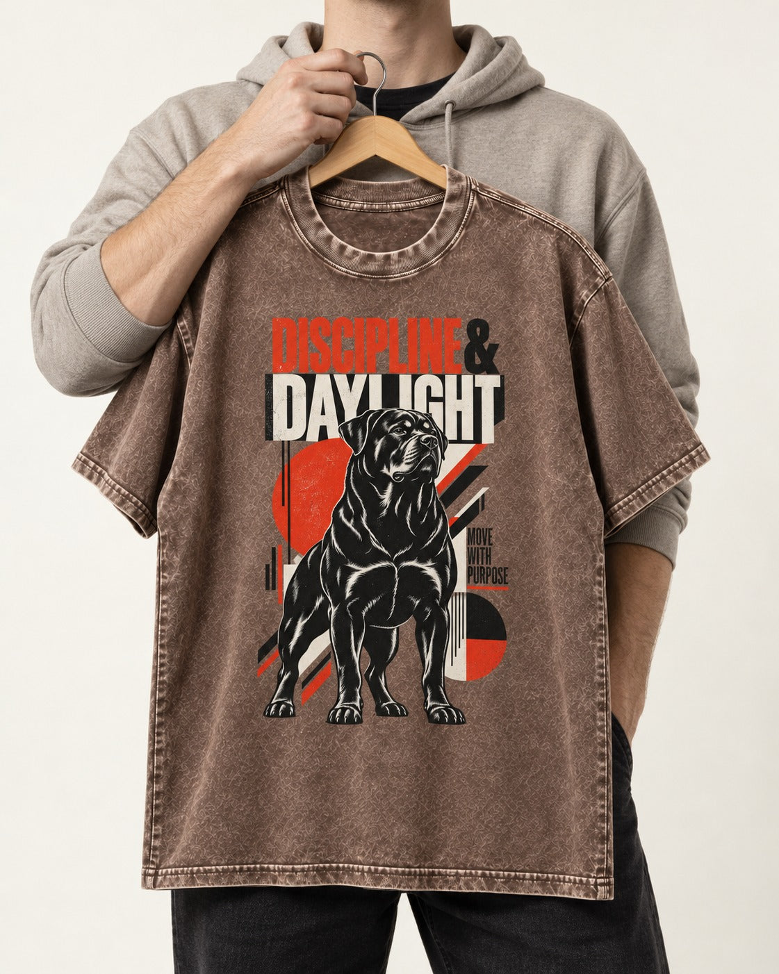 Discipline and Daylight Rottweiler Move With Purpose Washed Tee in Coffee, held up on a hanger