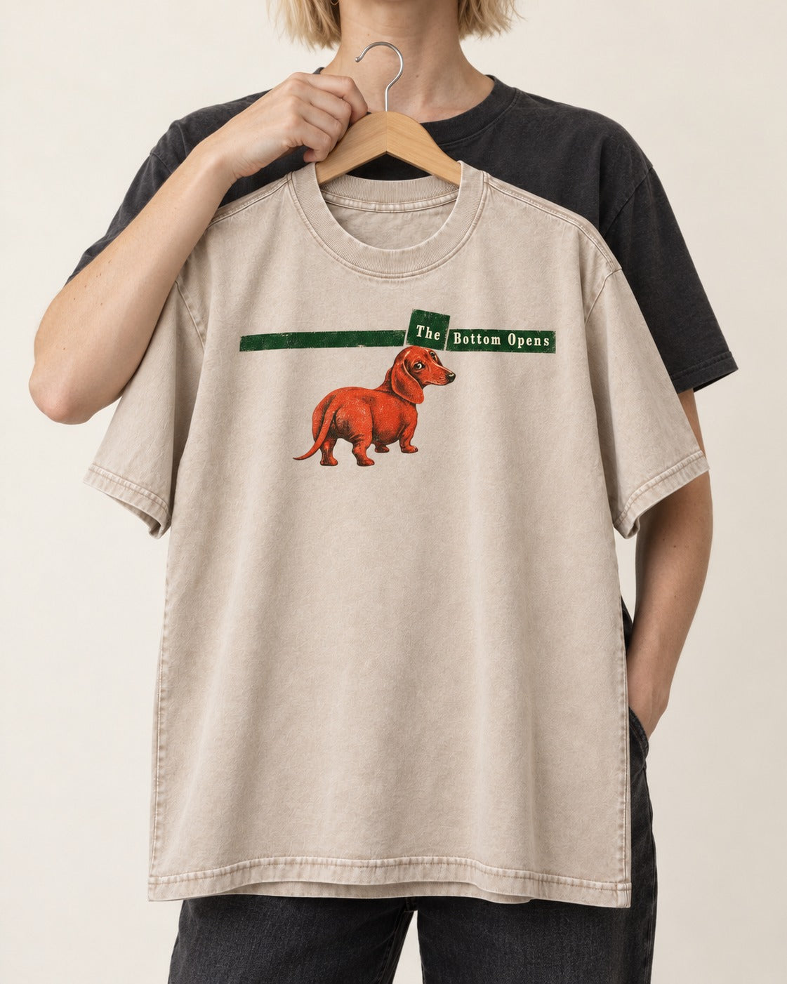 Dachshund The Bottom Opens Signpost Graphic Washed Tee in Apricot, held up on a hanger