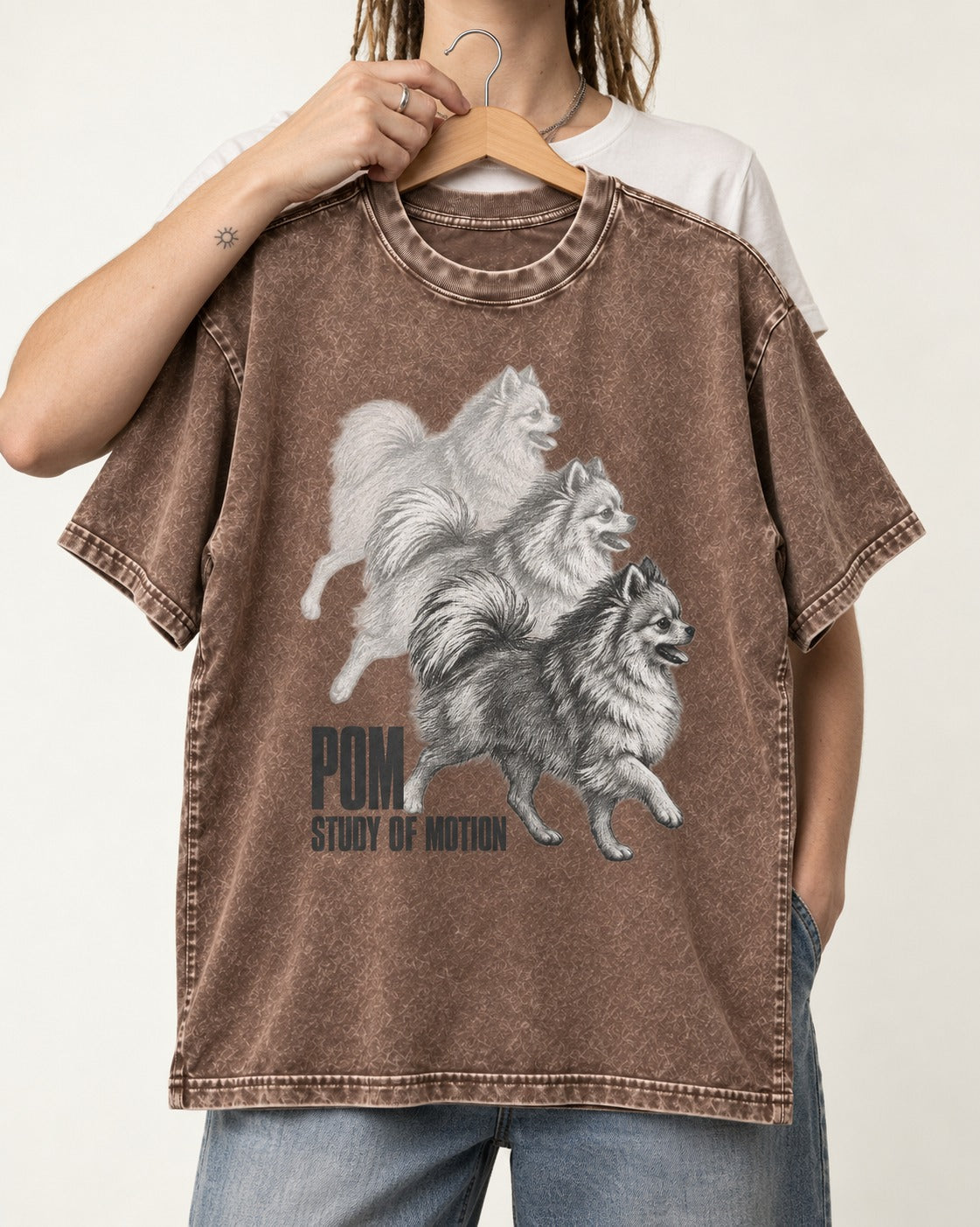 Pomeranian Study of Motion Washed Tee in Coffee, held up on a hanger