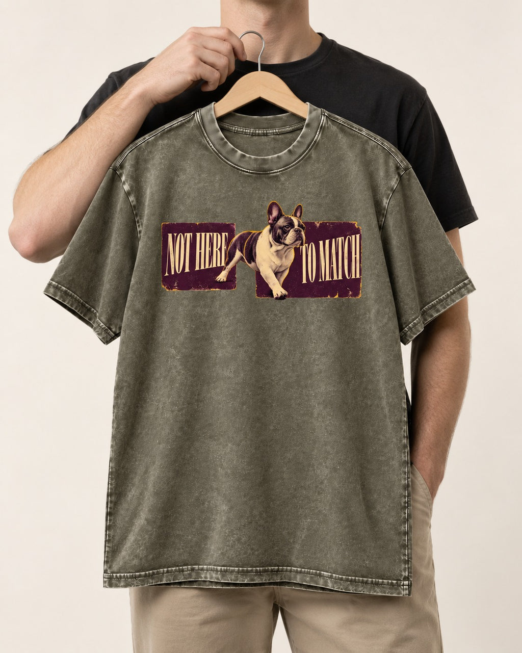 Frenchie Not Here to Watch Panels Graphic Washed Tee in Army Green, held up on a hanger
