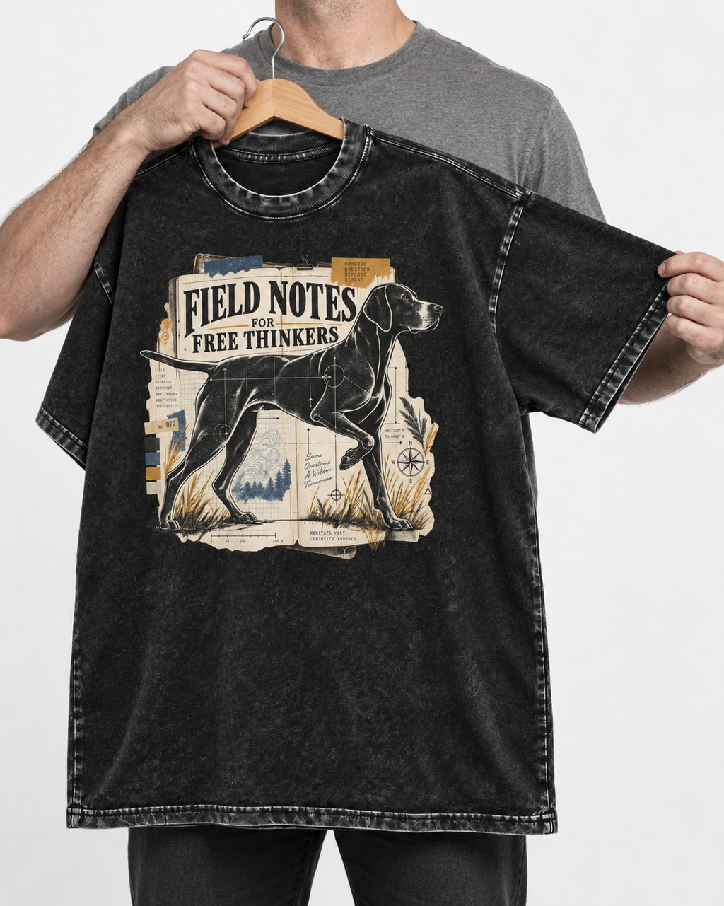 Field Notes for Free Thinkers Collage German Shorthaired Pointer Graphic Washed Tee in Black, held up on a hanger