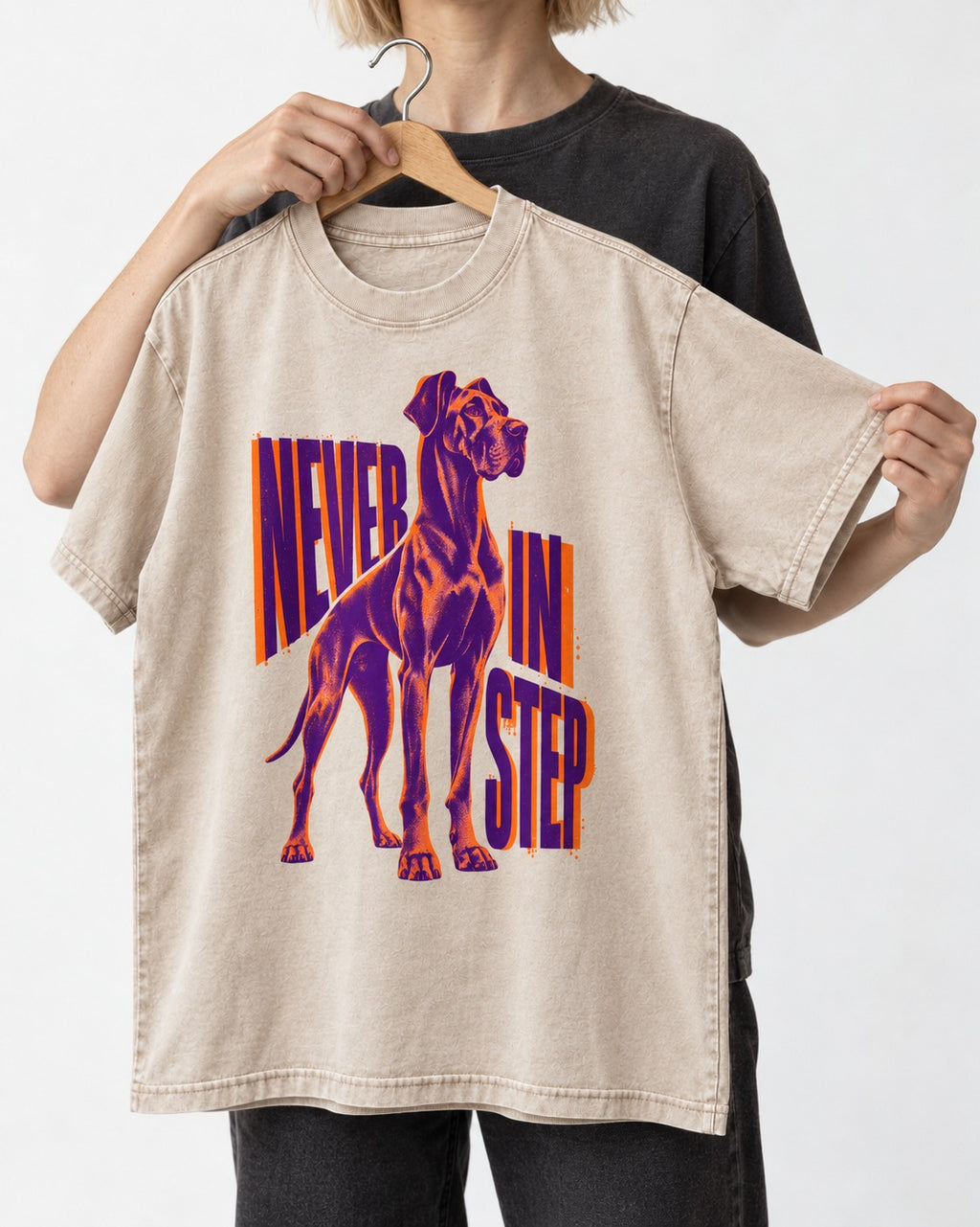 Great Dane Never in Step Standing Graphic Washed Tee in Apricot, held up on a hanger