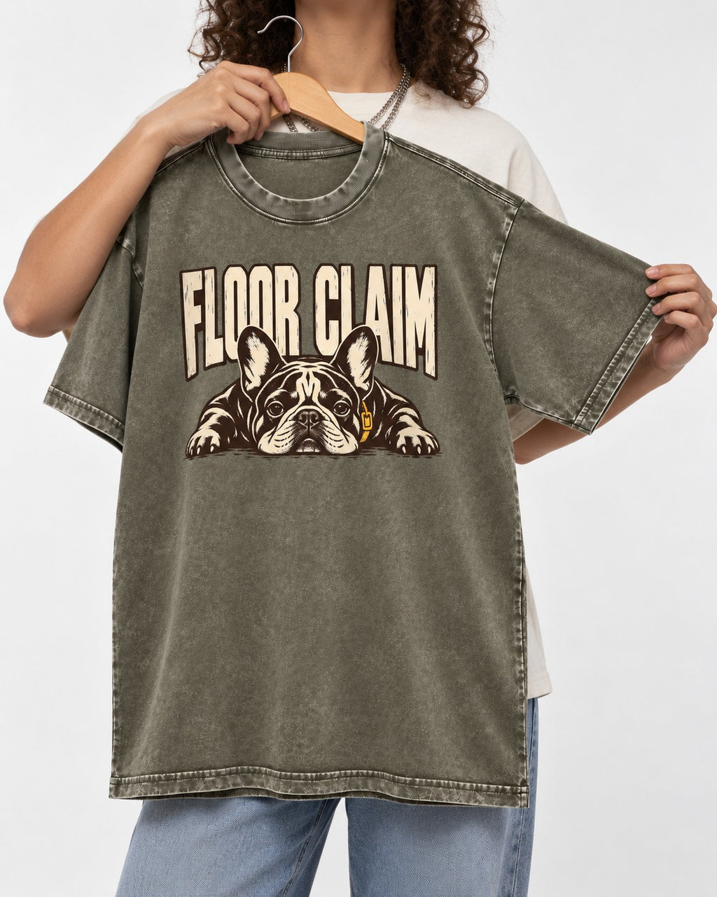 Frenchie Floor Claim Resting Graphic Washed Tee in Army Green, held up on a hanger