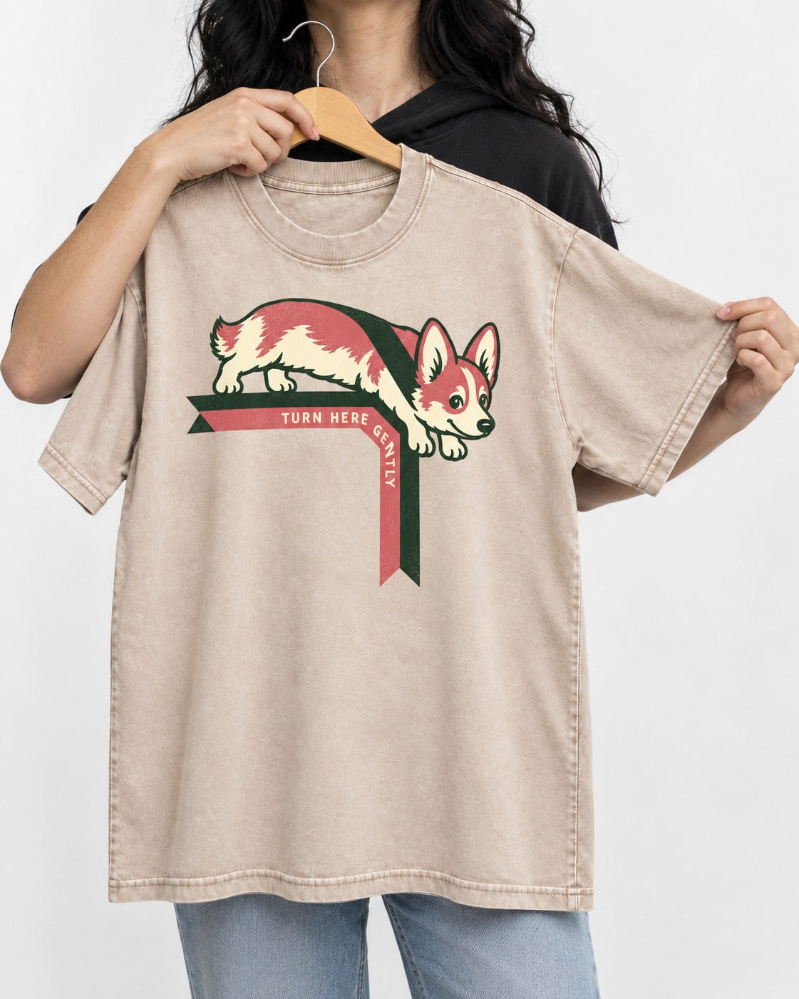 Corgi Turn Here Gently Washed Tee in Apricot, held up on a hanger