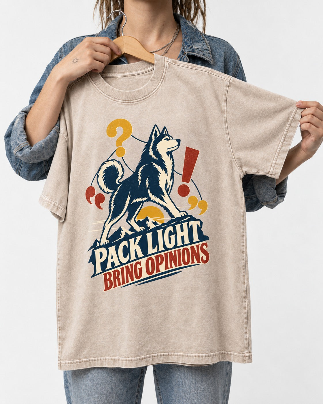 Husky Pack Light Bring Opinions Washed Tee in Apricot, held up on a hanger