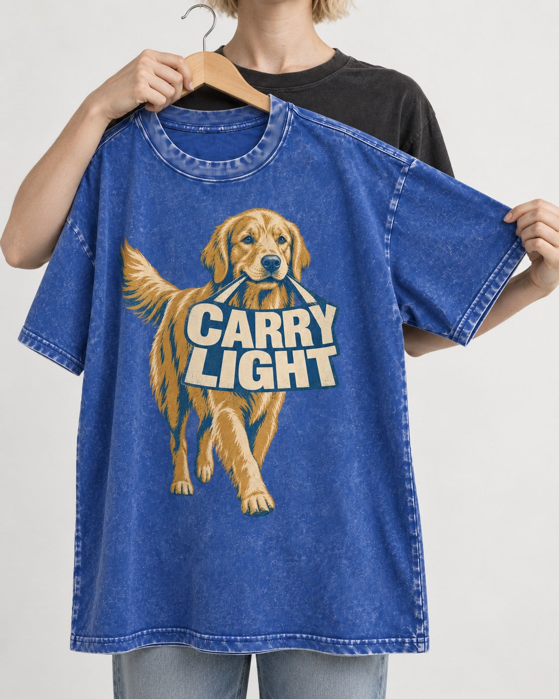Golden Retriever Carry Light Sign Graphic Washed Tee in Royal Blue, held up on a hanger