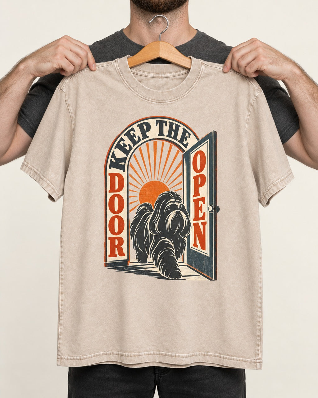 Shih Tzu Keep the Door Open Retro Doorway Graphic Washed Tee in Apricot, held up on a hanger