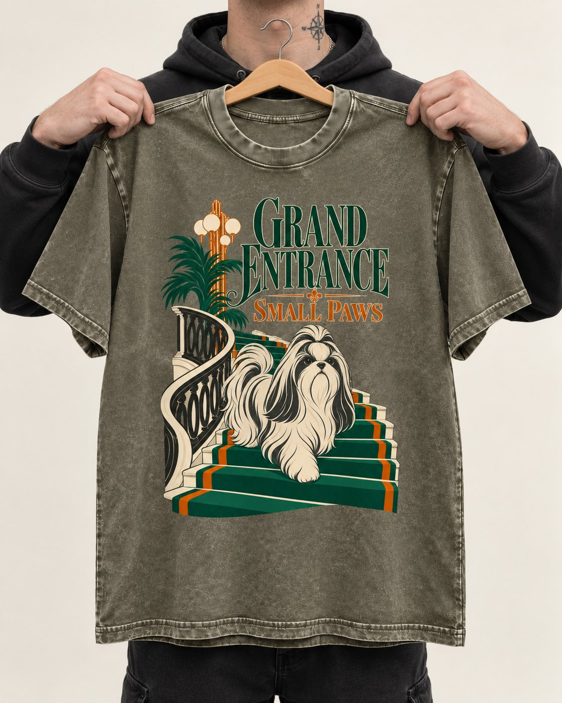 Shih Tzu Grand Entrance Small Paws Staircase Graphic Washed Tee in Army Green, held up on a hanger