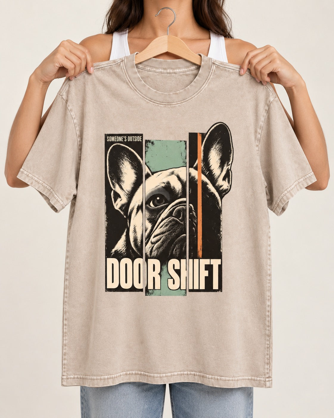 Frenchie Someone's Outside Door Shift Graphic Washed Tee in Apricot, held up on a hanger