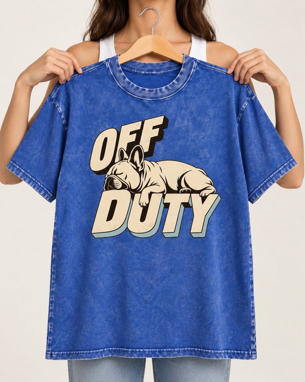 Frenchie Off Duty Sleeping Type Graphic Washed Tee in Royal Blue, held up on a hanger