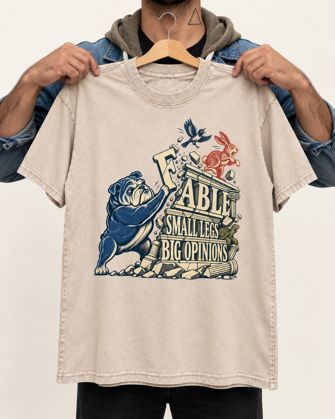Small Legs Big Opinions English Bulldog Washed Tee in Apricot, held up on a hanger
