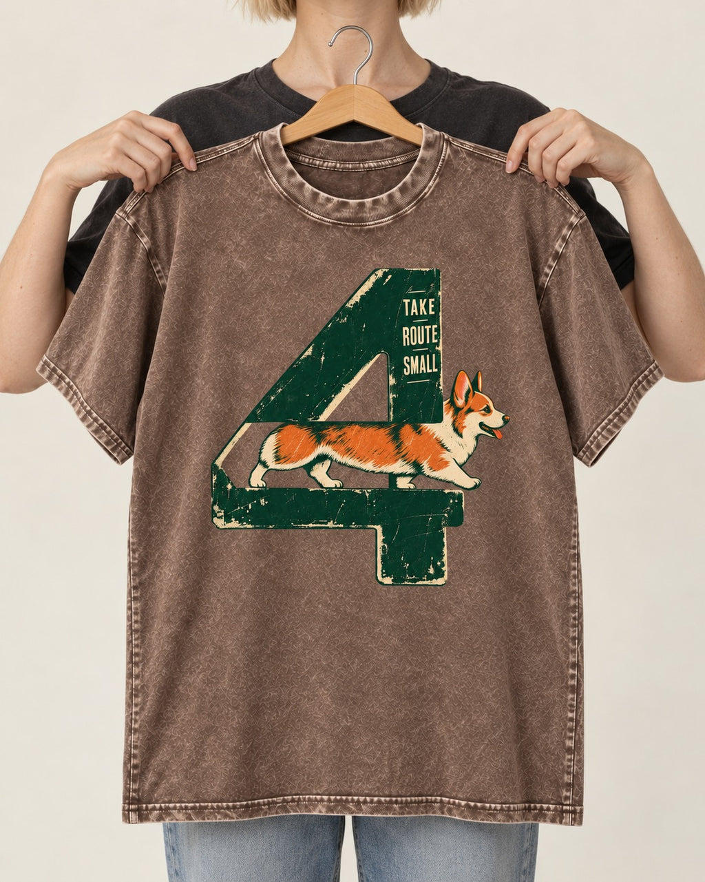 Take Route Small Corgi Washed Tee in Coffee, held up on a hanger