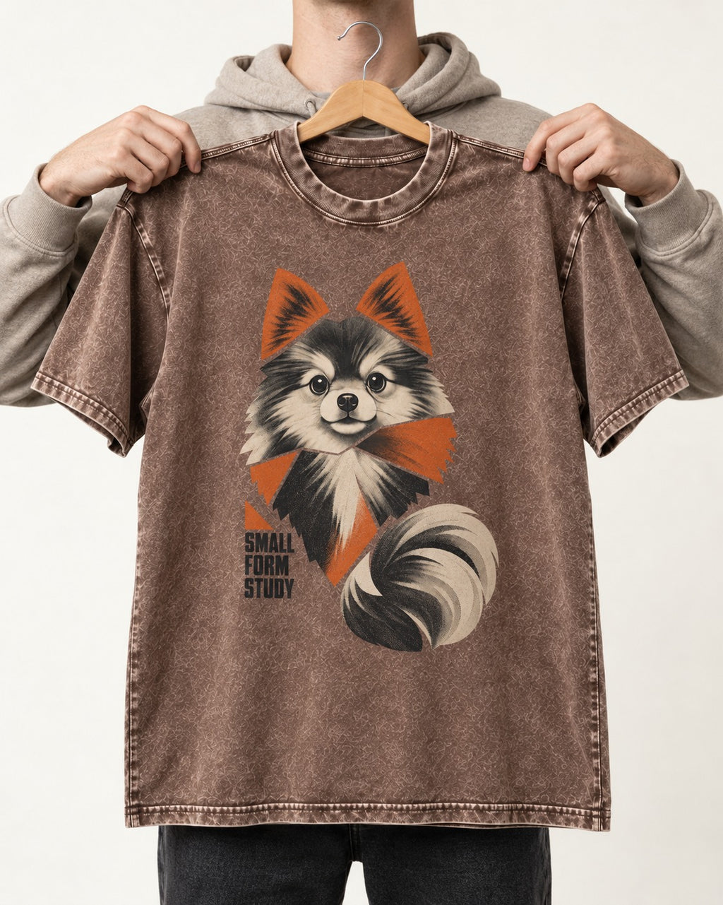 Pomeranian Small Form Study Washed Tee in Coffee, held up on a hanger