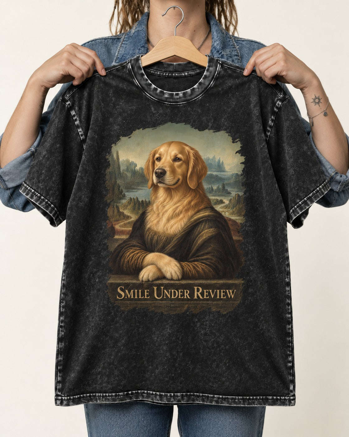 Smile Under Review Renaissance Portrait Golden Retriever Graphic Washed Tee in Black, held up on a hanger