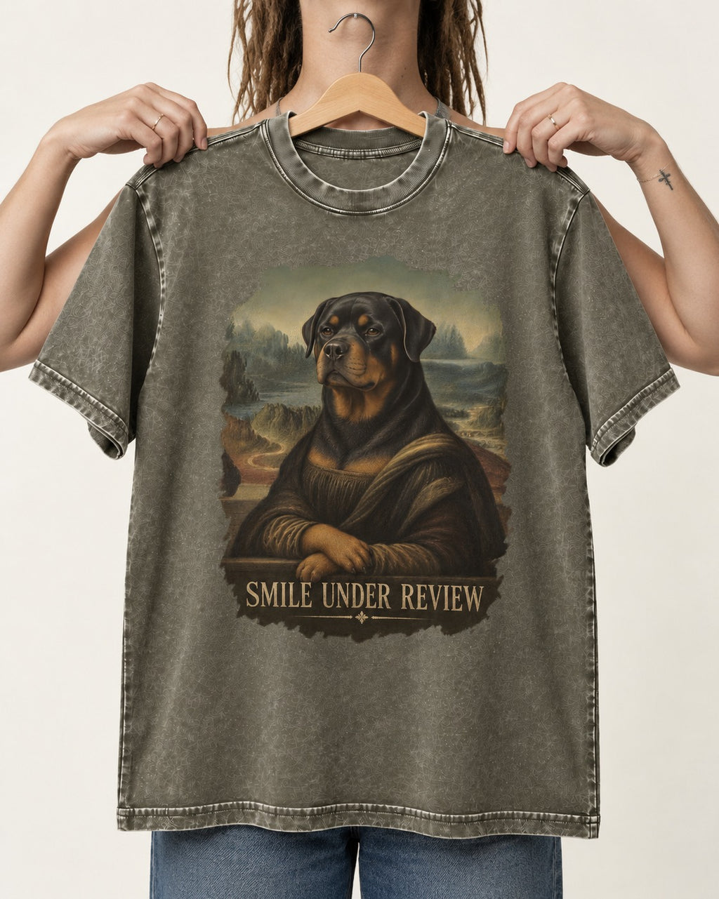 Rottweiler Smile Under Review Renaissance Portrait Graphic Washed Tee in Army Green, held up on a hanger