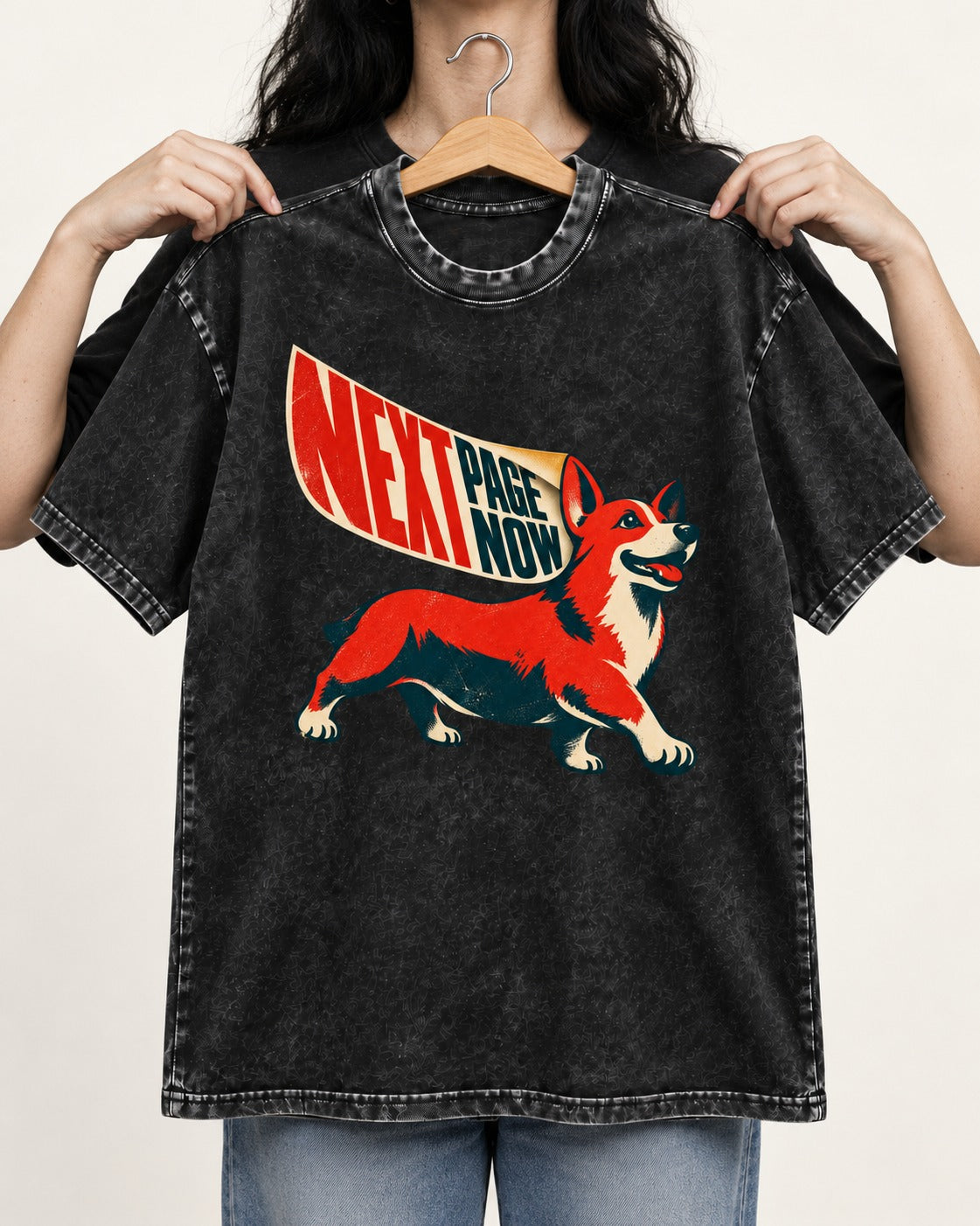 Corgi Next Page Now Pennant Graphic Washed Tee in Black, held up on a hanger