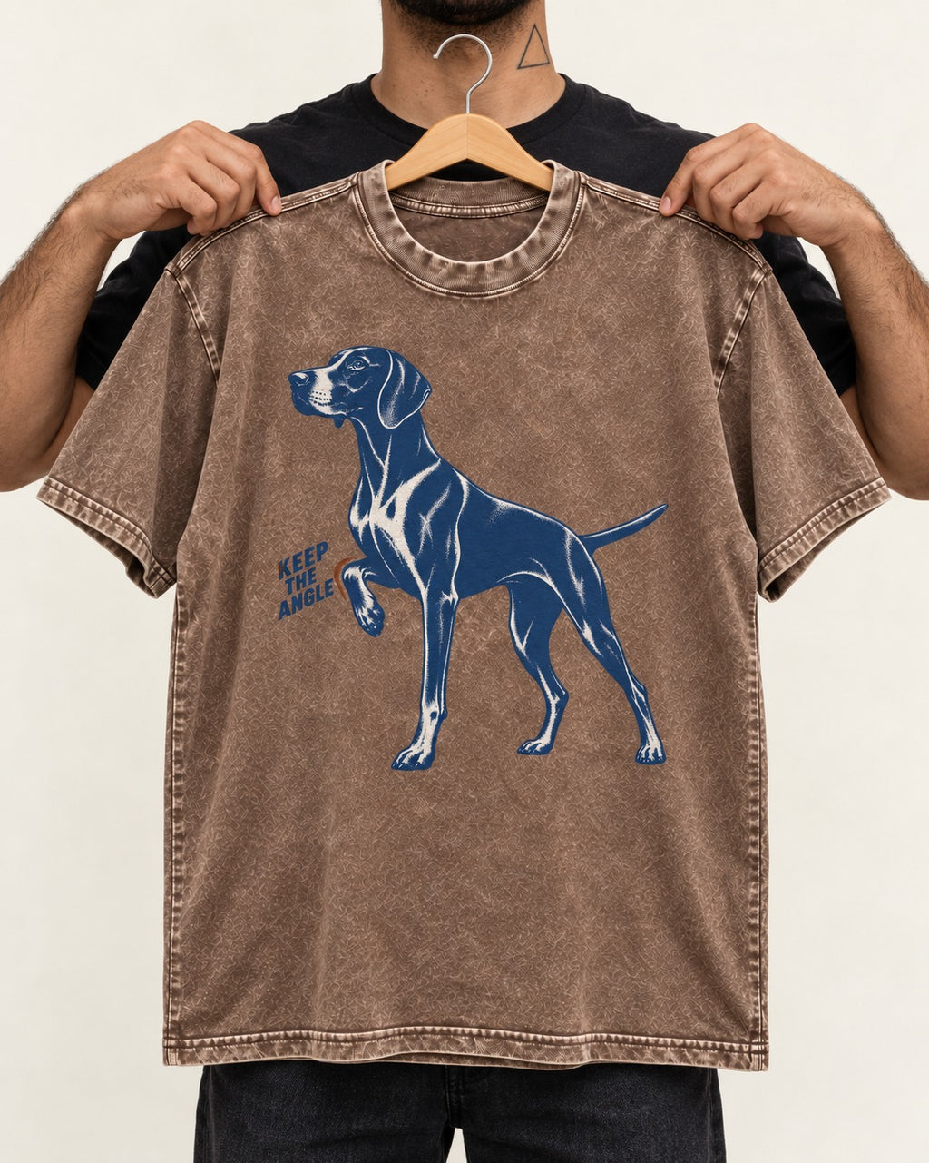 Keep the Angle German Shorthaired Pointer Washed Tee in Coffee, held up on a hanger