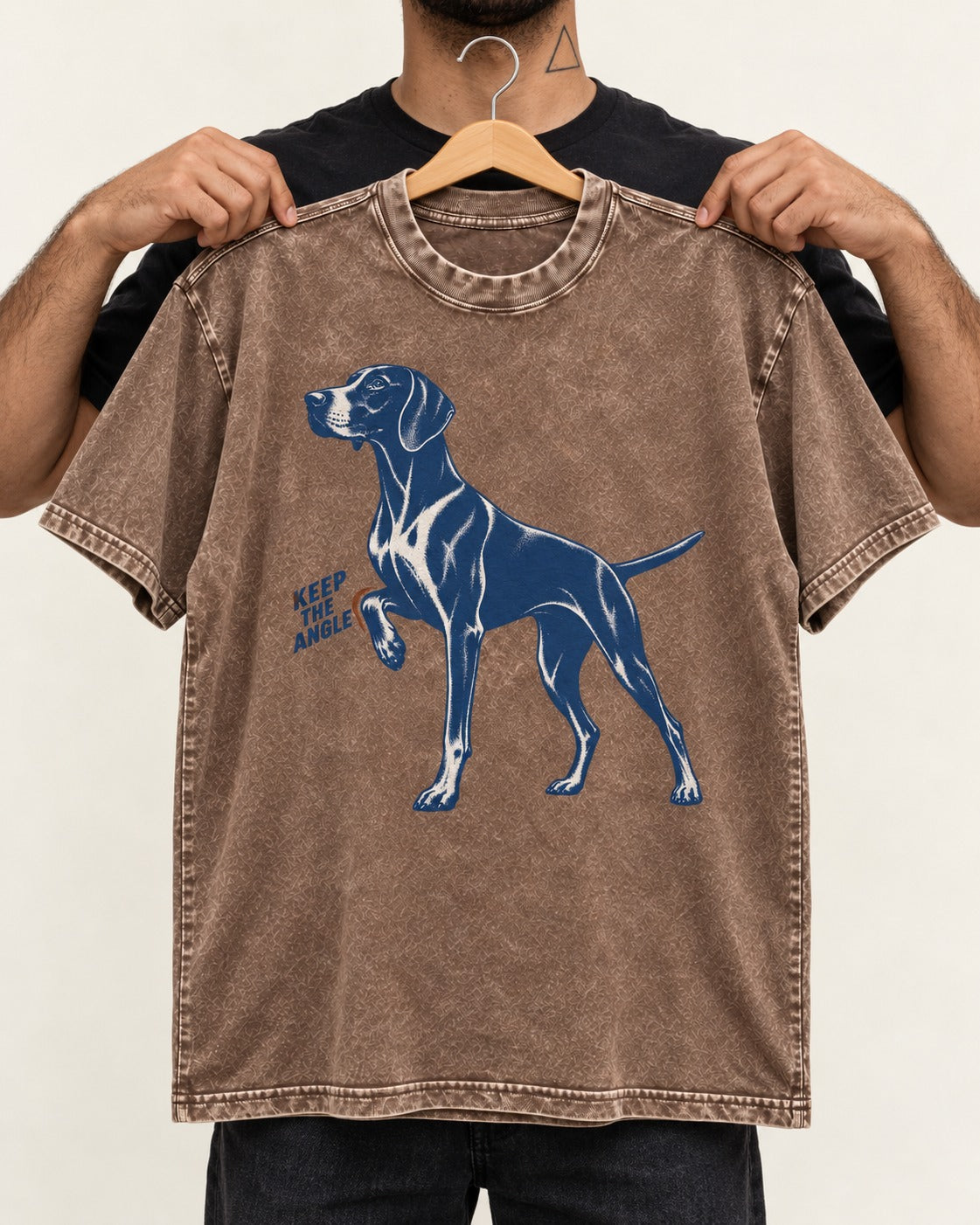 Keep the Angle German Shorthaired Pointer Washed Tee in Coffee, held up on a hanger