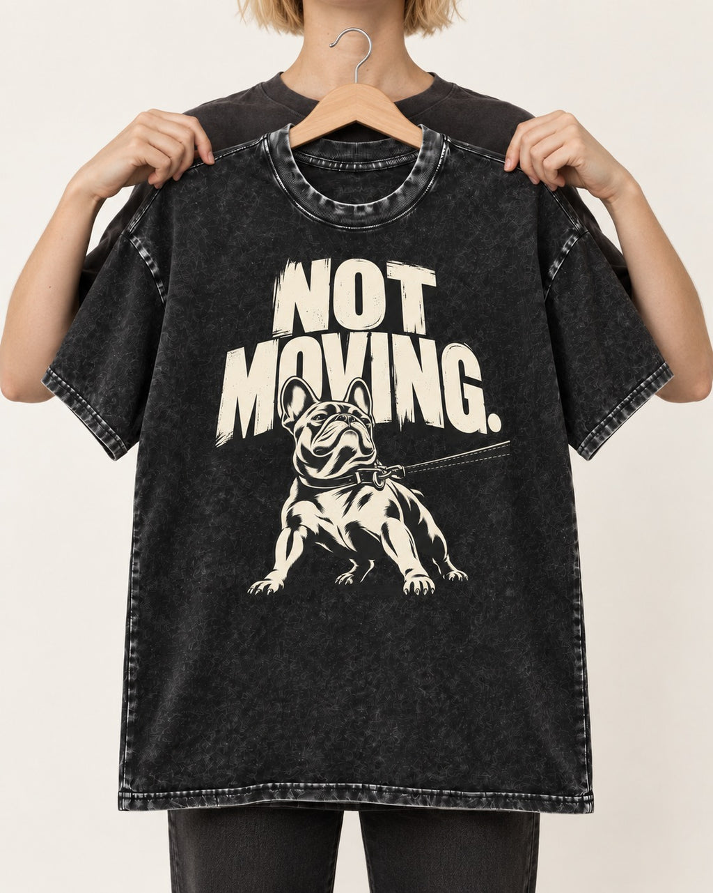 Frenchie Not Moving Taut Leash Poster Washed Tee in Black, held up on a hanger