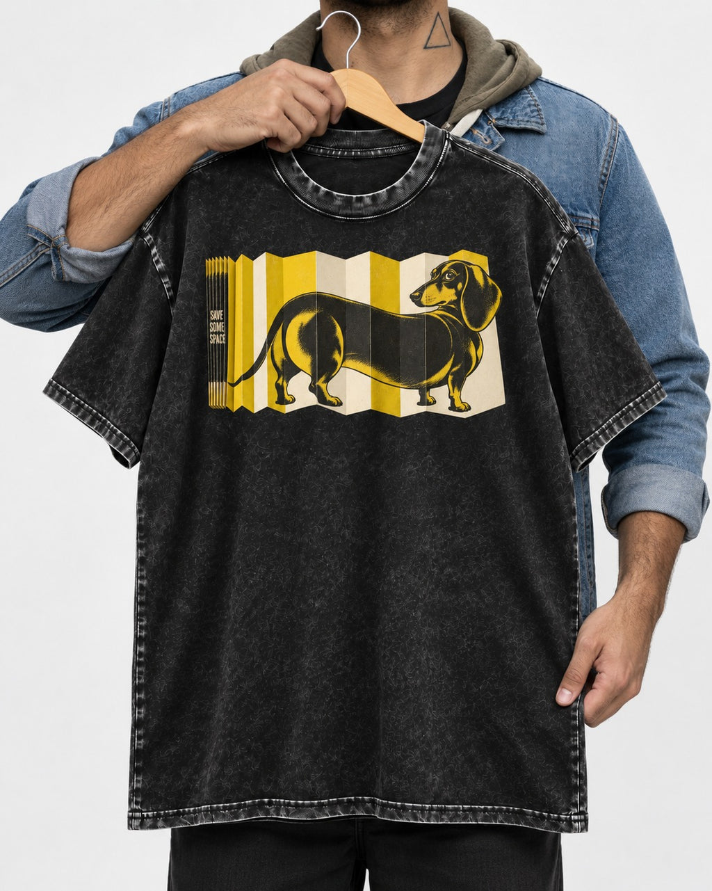 Dachshund Save Some Space Accordion Screen Graphic Washed Tee in Black, held up on a hanger
