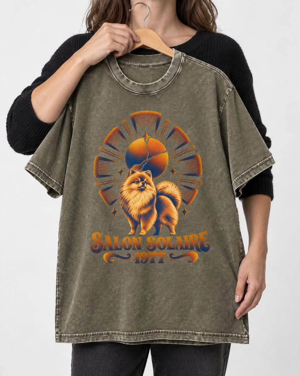 Pomeranian Salon Solaire 1977 Hairbrush Halo Graphic Washed Tee in Army Green, held up on a hanger