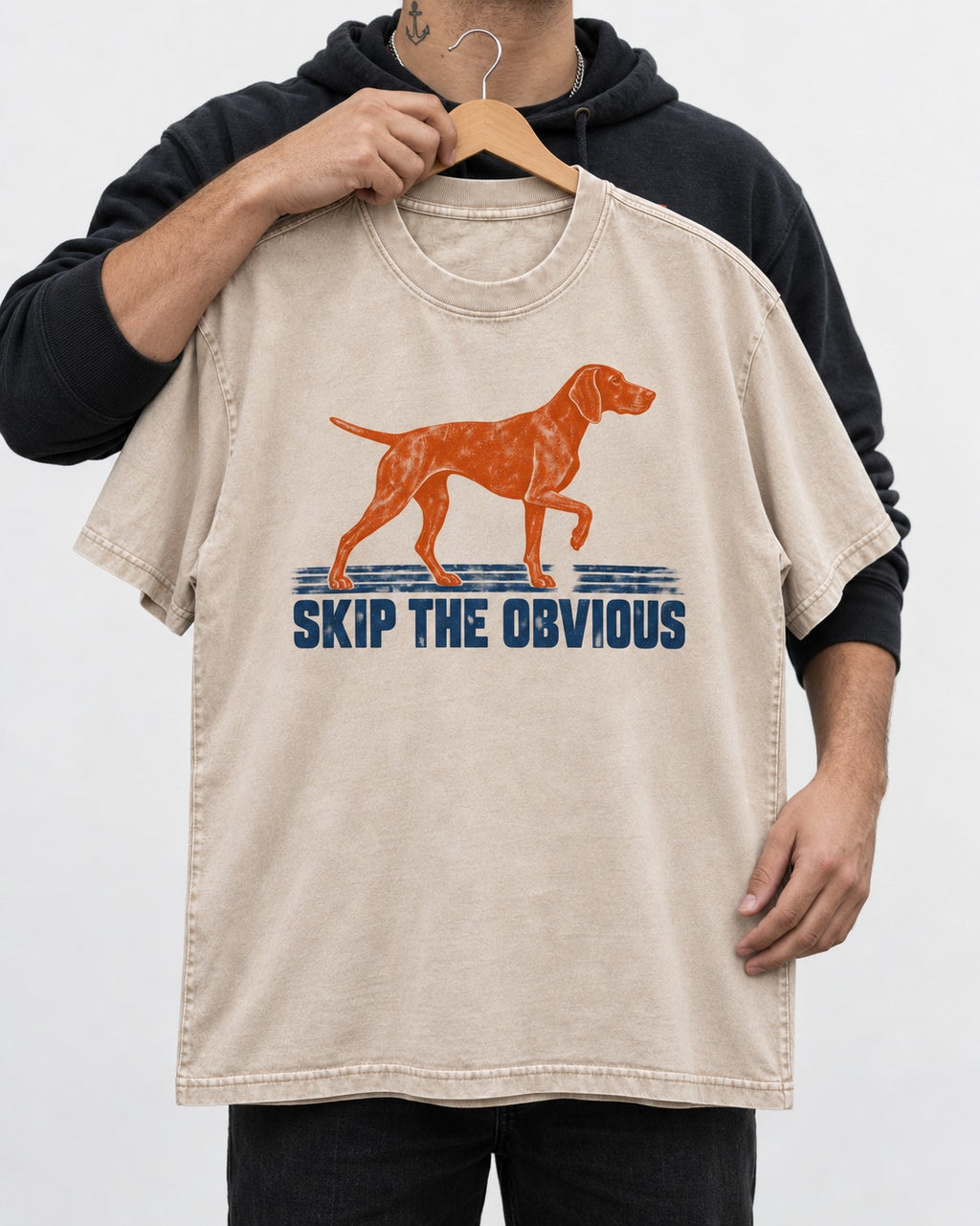 Skip the Obvious German Shorthaired Pointer Washed Tee in Apricot, held up on a hanger