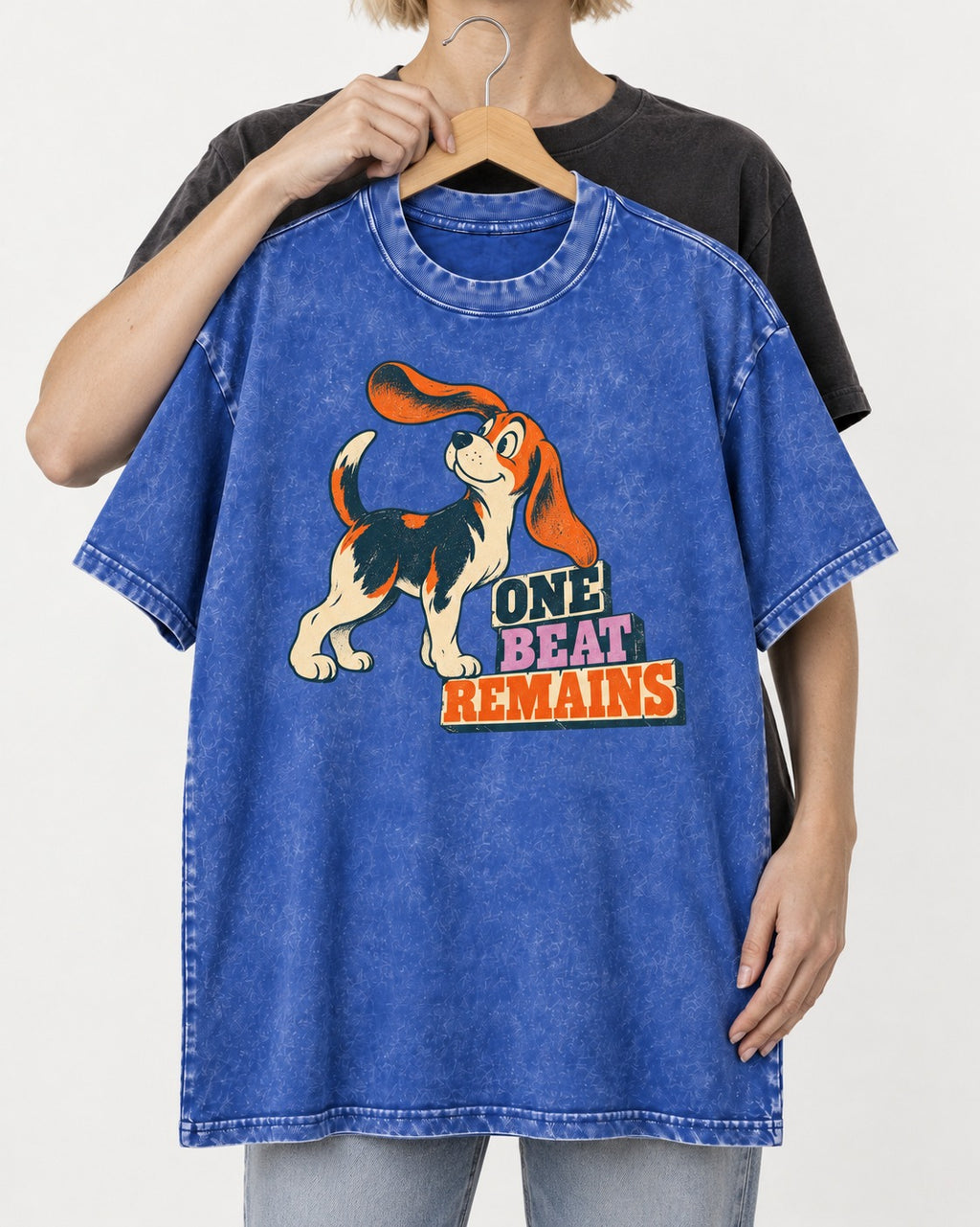 Retro Beagle One Beat Remains Washed Tee in Royal Blue, held up on a hanger