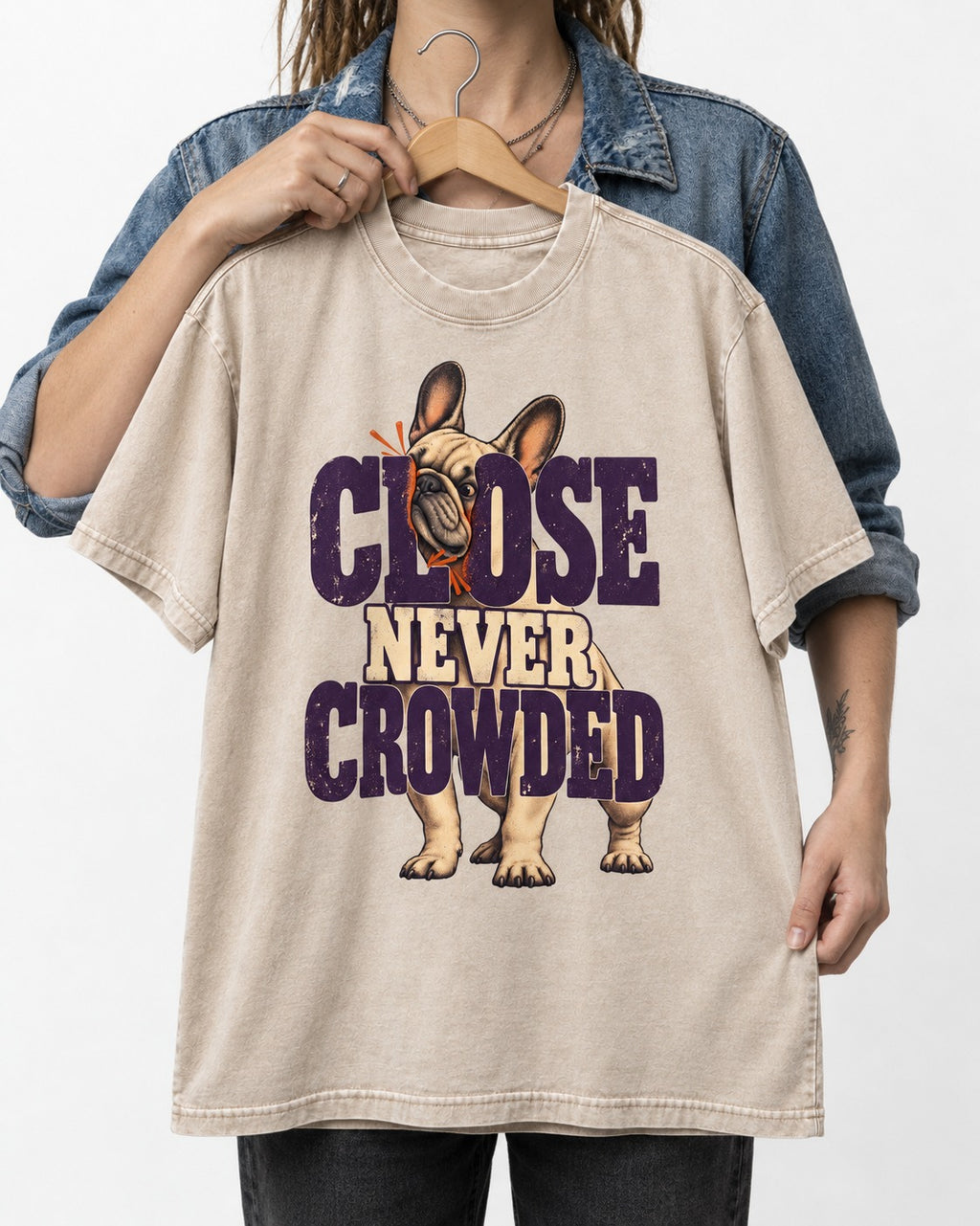 Frenchie Close Never Crowded Peekaboo Type Graphic Washed Tee in Apricot, held up on a hanger