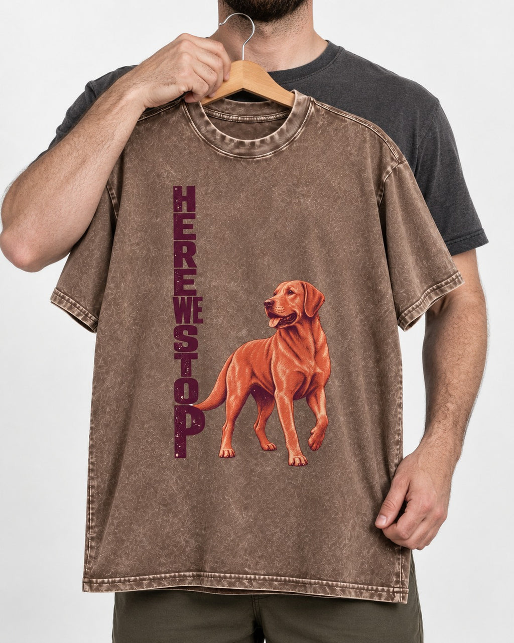 Here We Stop Labrador Retriever Washed Tee in Coffee, held up on a hanger