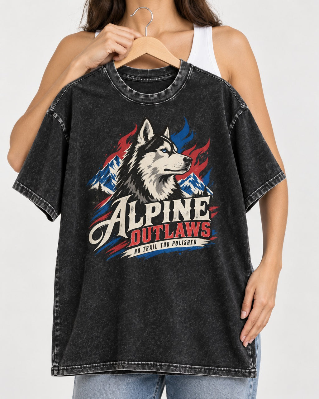 Husky Alpine Outlaws No Trail Too Polished Graphic Washed Tee in Black, held up on a hanger