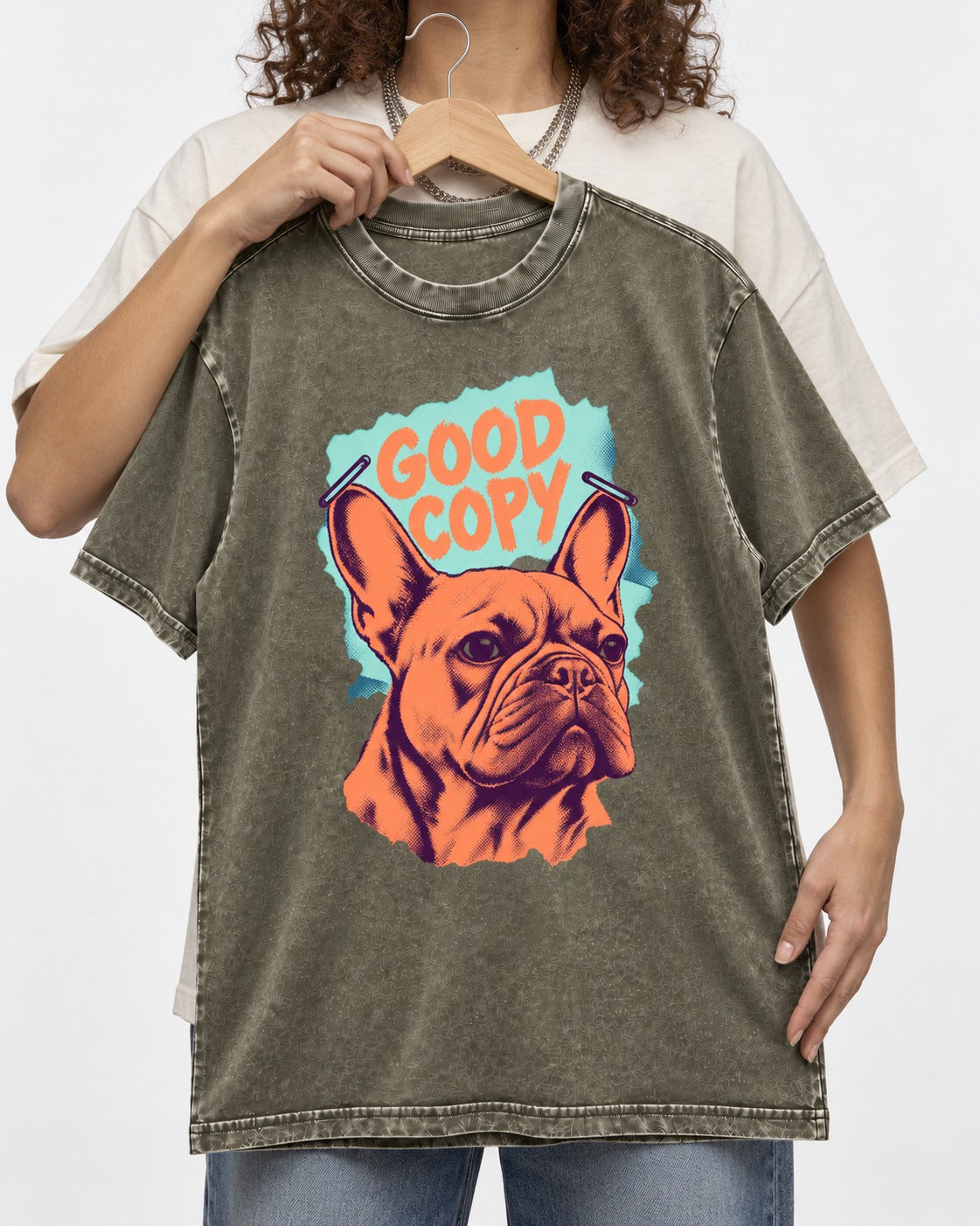 Frenchie Good Copy Stapled Zine Graphic Washed Tee in Army Green, held up on a hanger