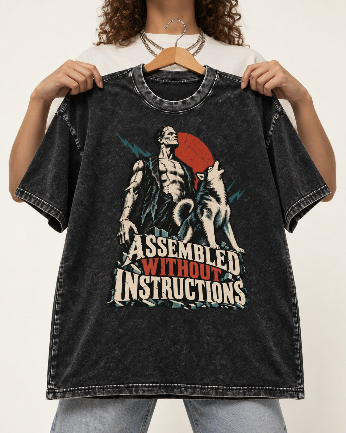 Husky Assembled Without Instructions Frankenstein Graphic Washed Tee in Black, held up on a hanger
